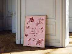 a pink sign sitting on top of a hard wood floor next to a doorway with white walls