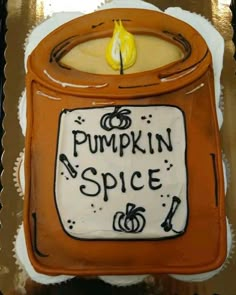 there is a cake that says pumpkin spice on the front and side with a candle in it