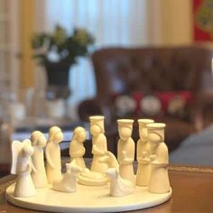 a close up of a chess set on a table with a couch in the background