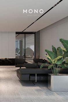 a modern living room with black furniture and large plants in the center, along with mono logo