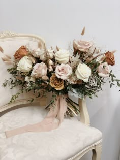 a bouquet of flowers sitting on top of a white chair