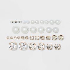 Stud earring set from Wild Fable™. Includes 18 pairs of round stud earrings in graduating sizes. Nine pairs are milky pearlized earrings and nine pairs are gold-finished earrings with clear rhinestone rounds. Post back closures provide comfortable wear.

If you’re not satisfied with any Target Owned Brand item, return it within one year with a receipt for an exchange or a refund.

Wild Fable™: A look for every story. Candle Pedestal, Buy Pearls, Flower Stud, Round Stud Earrings, Rhinestone Studs, Flower Earrings Studs, Stud Earrings Set, Flower Studs, Wild Fable