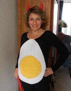 a woman in devil horns is holding an egg costume