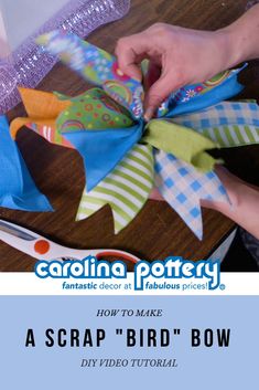 someone is cutting fabric with scissors on a wooden table and the words carolina pottery how to make a scrap bird bow