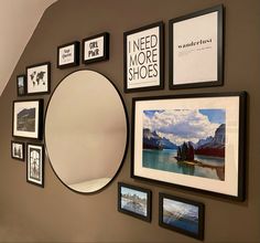 a wall with many pictures on it and a round mirror