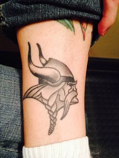 a tattoo on the leg of a person with a bulls head and horns on it