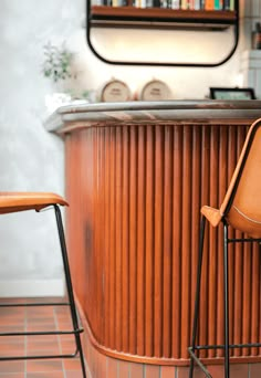 two chairs sitting next to each other in front of a bar