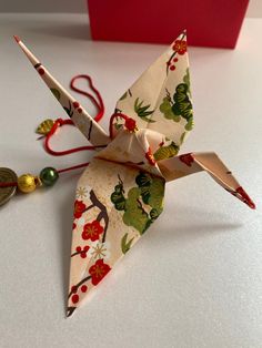 an origami bird is sitting on the table