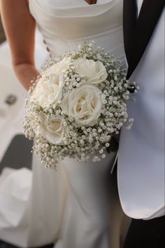 the bride and groom are holding their bouquets in their hands while standing next to each other