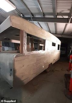 an old boat is being worked on in a garage