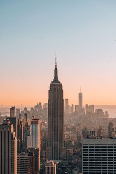 the empire building in new york city is seen at sunset from atop the empire state building