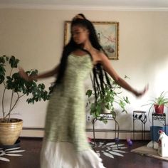 a woman in a long dress is dancing