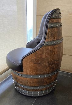 a large wooden barrel chair sitting in front of a window