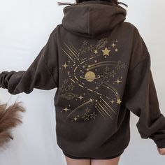 Star Galaxy Sweatshirt, the perfect addition to your y2k clothing collection. This celestial-inspired hoodie features a breathtaking galaxy print that will transport you to the depths of outer space. Made from high-quality materials, this hoodie offers both comfort and style, making it perfect for everyday wear. The shooting star design adds a touch of whimsy, while the cozy interior provides warmth during cooler seasons. Don't miss out on this trendy and eye-catching galaxy sweatshirt, a must-h Space Aesthetic Clothes, Hoodie Print Design Ideas, Clothes Print Design, Spacecore Fashion, Spacecore Outfits, Graphic Hoodie Design, Galaxy Clothes, Stars Outfit, Space Clothes