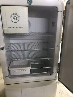 an open refrigerator sitting on top of a counter