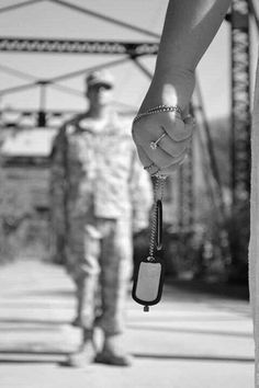 a person holding a car key in their hand while another man stands next to him