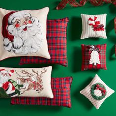 christmas pillows with santa claus on them and other holiday decorations around the pillowcases