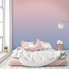 a bedroom with pink and blue ombreed walls