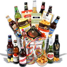 an assortment of beer and snacks in a bucket