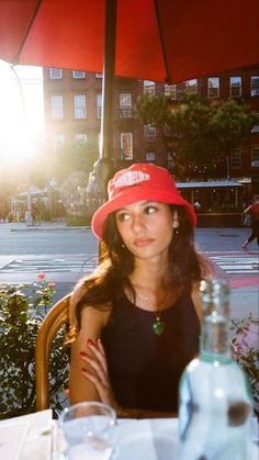 a woman wearing a red hat sitting at a table