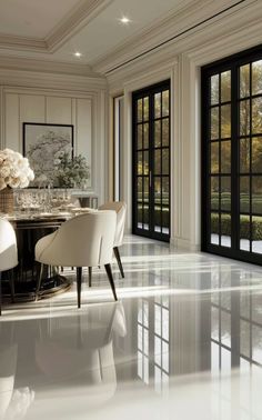 an elegant dining room with large windows and marble flooring is seen in this image