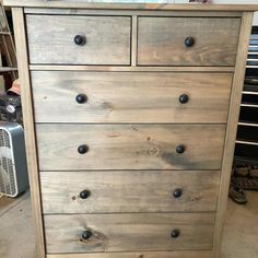 a wooden dresser sitting in a room next to a heater