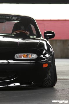 the front end of a black sports car