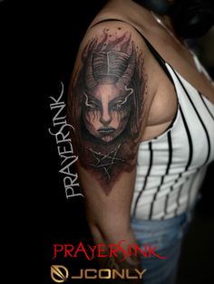 a woman with a demon head tattoo on her arm