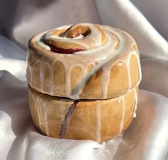 a pastry covered in icing sitting on top of a white cloth