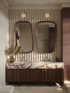 a bathroom with marble counter tops and two mirrors