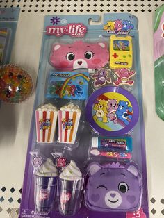 there is a purple bear and cupcakes in the package next to each other