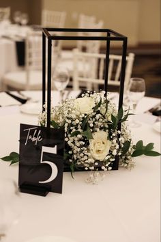 a table with flowers and place cards on it