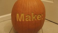 a pumpkin with the word make carved on it