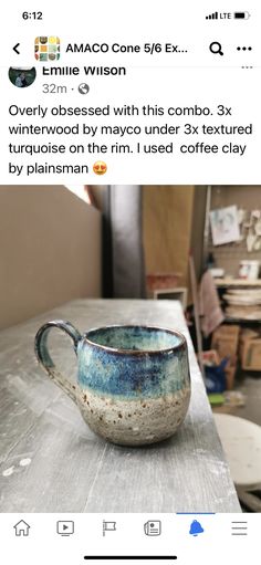 a coffee cup sitting on top of a wooden table