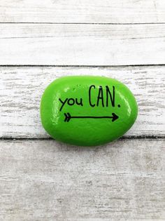 a green rock with the words you can written on it and an arrow pointing up