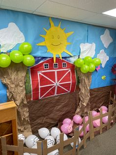 a room decorated with farm animals and balloons