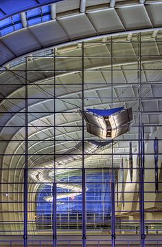 the inside of a building with glass walls and metal bars on it's sides