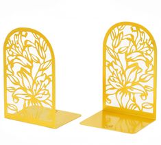 two yellow bookends with floral designs on them