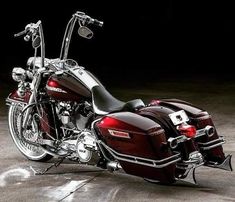 a red motorcycle parked on top of a cement floor