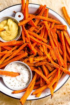 a white plate topped with sweet potato fries and dip