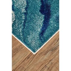 a blue area rug on top of a wooden floor