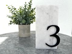 a marble table with a black number three on it