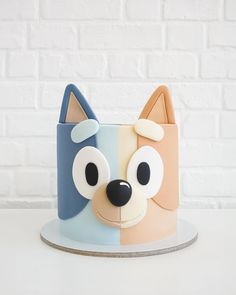 a close up of a cake with a dog design on it's face and eyes