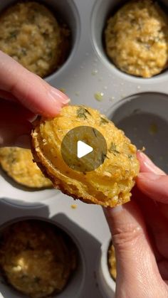 a person holding an egg in a muffin tin