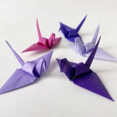 three origami cranes sitting on top of each other