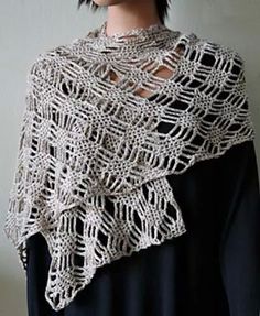 a woman wearing a white crocheted shawl