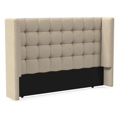 an upholstered headboard with black and beige fabric on the back, in front of a white background