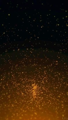 an orange and black background with small stars on the bottom right corner, yellow light in the middle