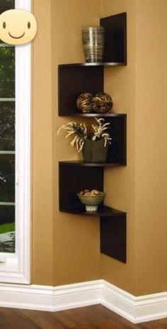 a corner shelf with pots and bowls on it next to a window in a room