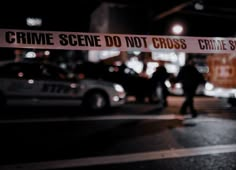 a police tape is taped off in front of some parked cars